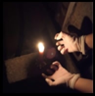 hands closed in a fist towards a candle